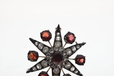 Lot 28 - Victorian garnet and white stone pendant brooch, starburst