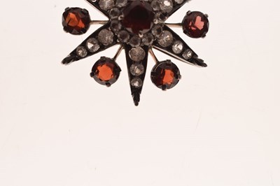 Lot 28 - Victorian garnet and white stone pendant brooch, starburst