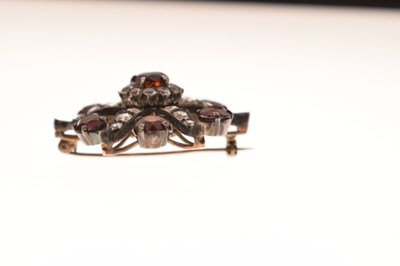 Lot 28 - Victorian garnet and white stone pendant brooch, starburst