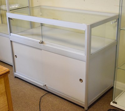Lot 754 - Modern glazed panelled and metal framed shop display low cabinet
