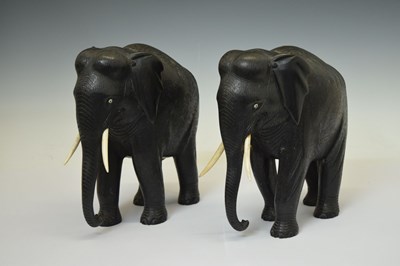 Lot 526 - Pair of ebony elephants with ivory tusks