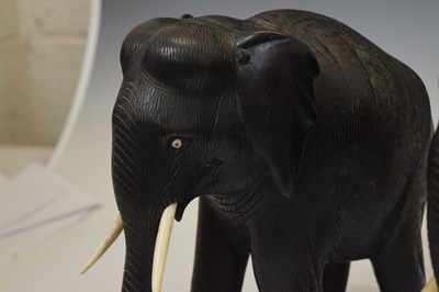 Lot 526 - Pair of ebony elephants with ivory tusks