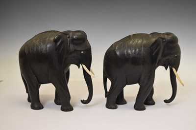 Lot 526 - Pair of ebony elephants with ivory tusks
