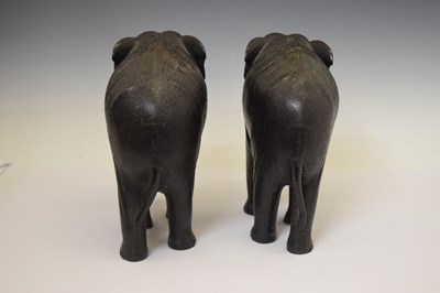 Lot 526 - Pair of ebony elephants with ivory tusks