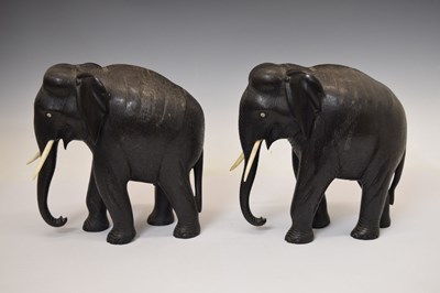 Lot 526 - Pair of ebony elephants with ivory tusks