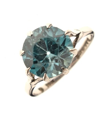 Lot 43 - Single stone ring set a blue-coloured faceted round stone