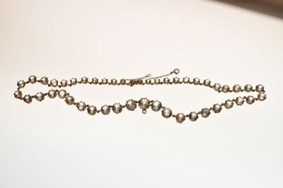Lot 55 - Yellow metal and white paste rivière necklace
