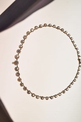 Lot 55 - Yellow metal and white paste rivière necklace