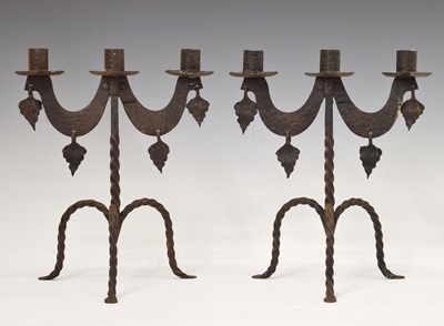 Lot 170 - Pair of wrought iron two-branch (three sconce) candlesticks