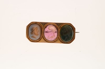 Lot 25 - Yellow metal brooch set three carved hardstone intaglios