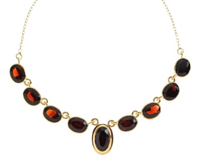 Lot 161 - Necklace, stamped '585', set nine oval faceted garnets