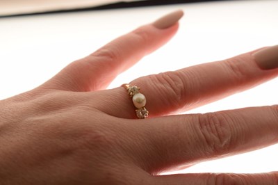 Lot 14 - Pearl and diamond yellow metal ring