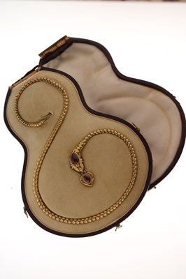 Lot 47 - Victorian garnet set yellow metal serpent pendant necklace, the textured snake head set with garnet carbuncle