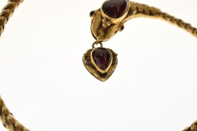 Lot 47 - Victorian garnet set yellow metal serpent pendant necklace, the textured snake head set with garnet carbuncle