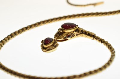 Lot 47 - Victorian garnet set yellow metal serpent pendant necklace, the textured snake head set with garnet carbuncle