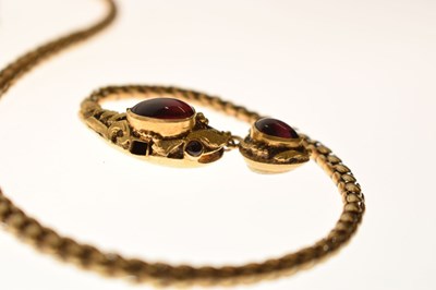 Lot 47 - Victorian garnet set yellow metal serpent pendant necklace, the textured snake head set with garnet carbuncle