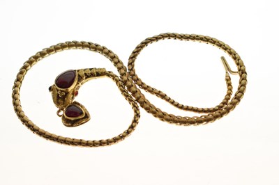 Lot 47 - Victorian garnet set yellow metal serpent pendant necklace, the textured snake head set with garnet carbuncle