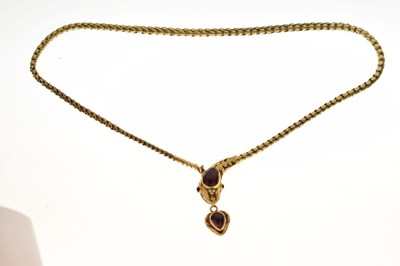 Lot 47 - Victorian garnet set yellow metal serpent pendant necklace, the textured snake head set with garnet carbuncle