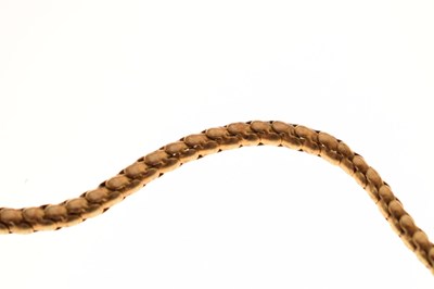 Lot 47 - Victorian garnet set yellow metal serpent pendant necklace, the textured snake head set with garnet carbuncle