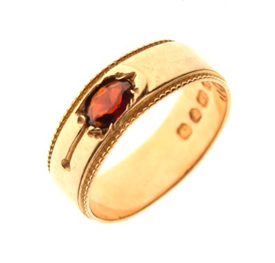 Lot 23 - 18ct gold band set garnet-coloured stone, size O, 5.3g gross approx