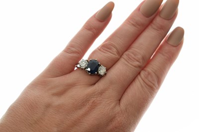 Lot 11 - Sapphire and diamond 18ct white gold three-stone ring