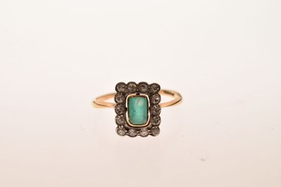 Lot 18 - Emerald and diamond 18ct yellow gold cluster ring