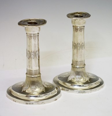 Lot 119 - Pair of George V silver candlesticks of oval form