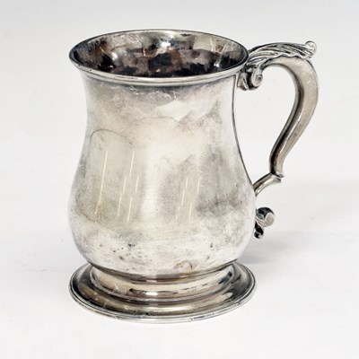 Lot 109 - George II silver mug of baluster form with acanthus-topped scroll handle