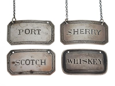 Lot 116 - Set of three white-metal decanter labels and a Victorian silver 'Whiskey' label