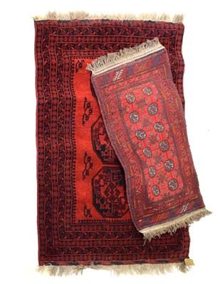Lot 501 - Two red ground rugs