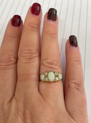 Lot 22 - Edwardian opal and diamond 18ct gold boat cluster ring