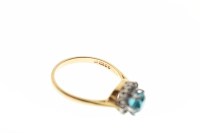 Lot 37 - Blue topaz-coloured stone and diamond cluster 18ct gold ring
