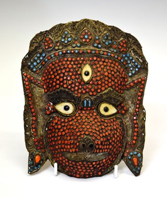 Lot 263 - South East Asian sheet brass mask, circa 1900