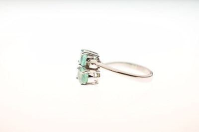 Lot 64 - 9ct white gold, Siberian emerald and diamond crossover ring