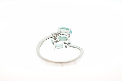 Lot 64 - 9ct white gold, Siberian emerald and diamond crossover ring