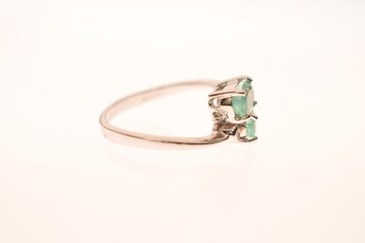 Lot 64 - 9ct white gold, Siberian emerald and diamond crossover ring