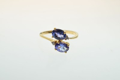 Lot 29 - Two-stone tanzanite and diamond 18ct gold crossover dress ring