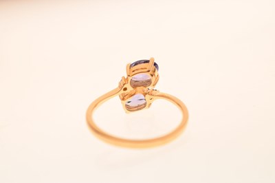 Lot 29 - Two-stone tanzanite and diamond 18ct gold crossover dress ring