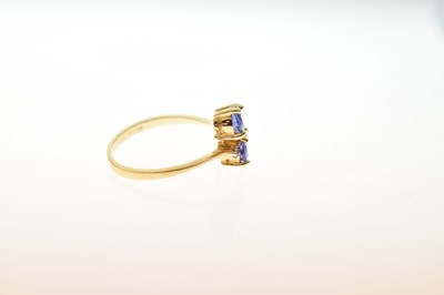 Lot 29 - Two-stone tanzanite and diamond 18ct gold crossover dress ring