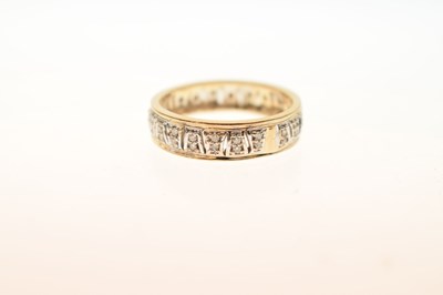 Lot 23 - 9ct yellow and white gold diamond set band