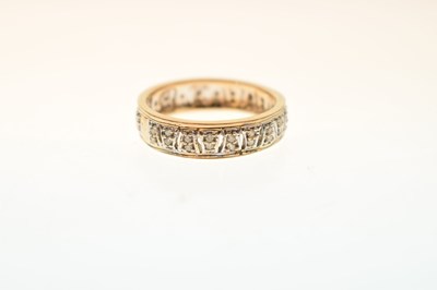 Lot 23 - 9ct yellow and white gold diamond set band