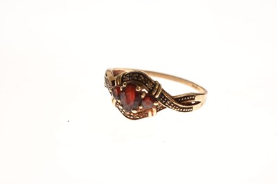 Lot 94 - Two red stone set rings and a pair of earrings