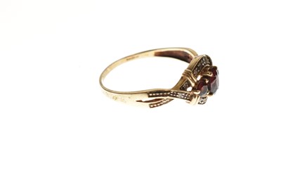 Lot 94 - Two red stone set rings and a pair of earrings