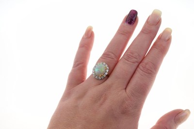 Lot 28 - Opal and diamond 18ct gold cluster ring
