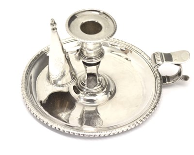Lot 168 - George III silver chamberstick of circular form with a beaded rim and scroll handle
