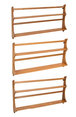 Lot 430 - Ercol - Three 'Golden Dawn' elm wall hanging plate racks