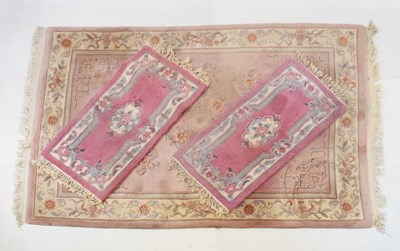 Lot 401 - Chinese pink ground rug