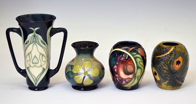 Lot 635 - Moorcroft - Twin-handled flared vase and three other vases