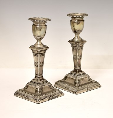 Lot 159 - Pair of silver candlesticks in the neoclassical taste of square columner form