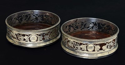 Lot 108 - Pair of George III silver-mounted wine coasters